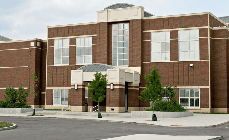 Two-story brick building with large windows.