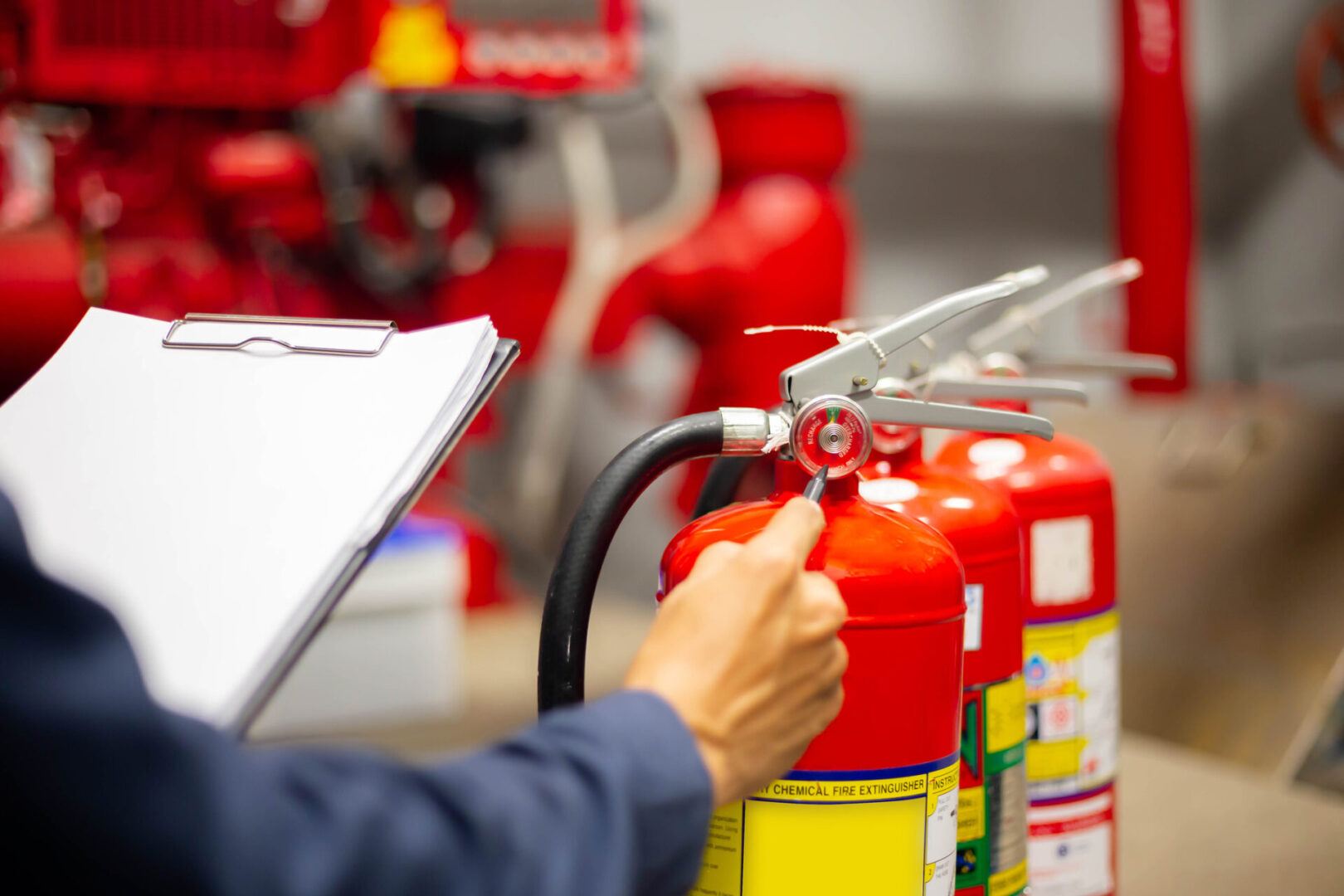 Inspecting fire extinguisher with a clipboard.