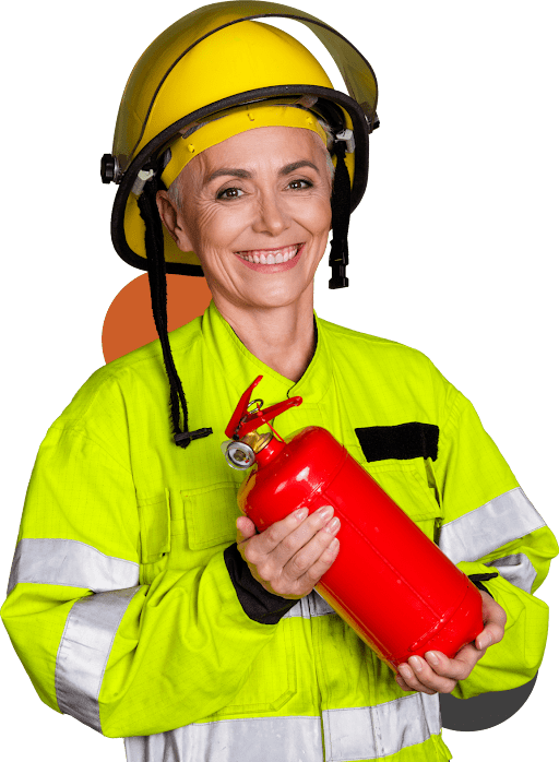 Firefighter smiling, holding red fire extinguisher.